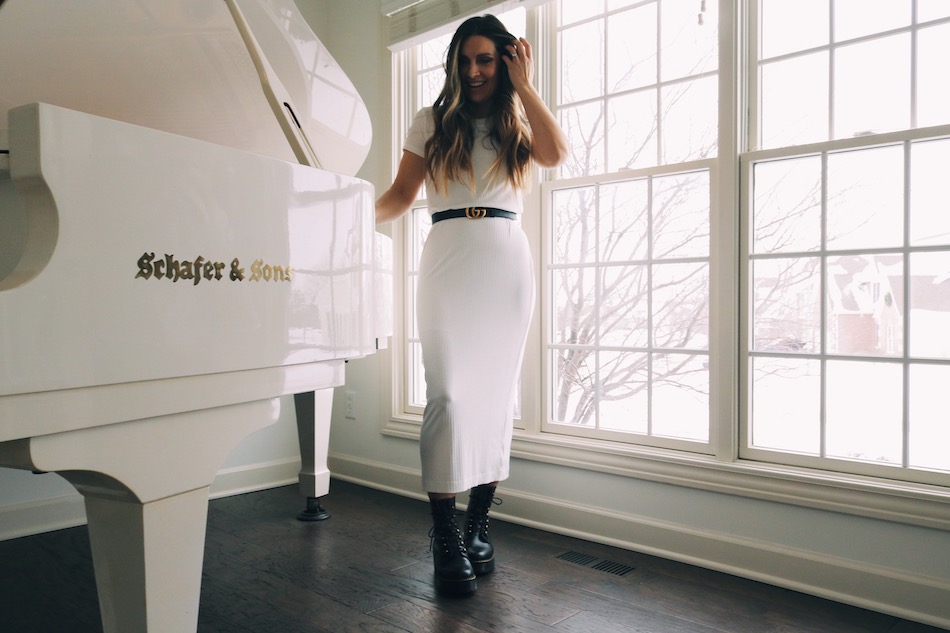 Alissa DeGroote standing by white grand piano